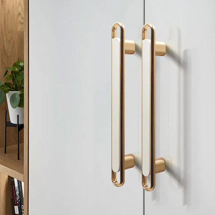 Gold Zinc Alloy Bar Pulls on white cabinet doors