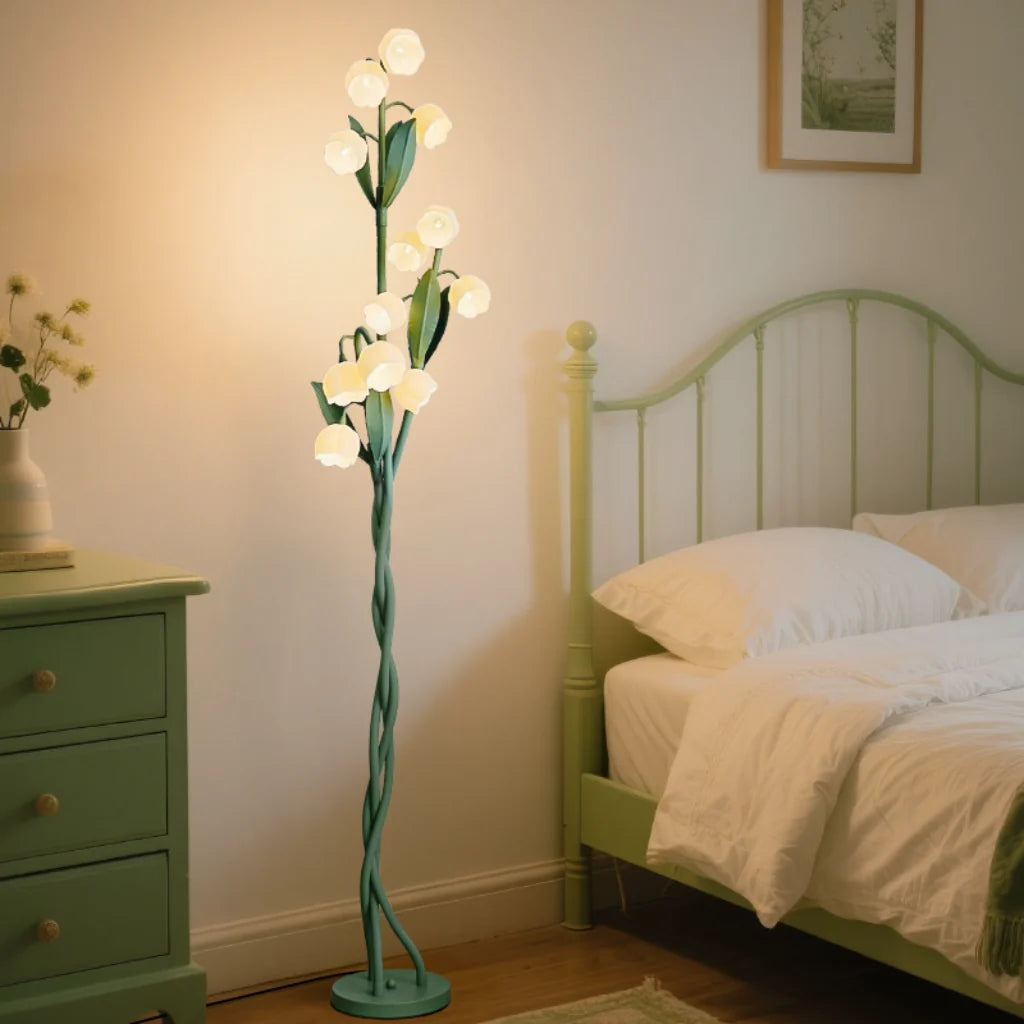 Lily Bloom Acrylic Floor Lamp glowing warm white light in a bedroom setting