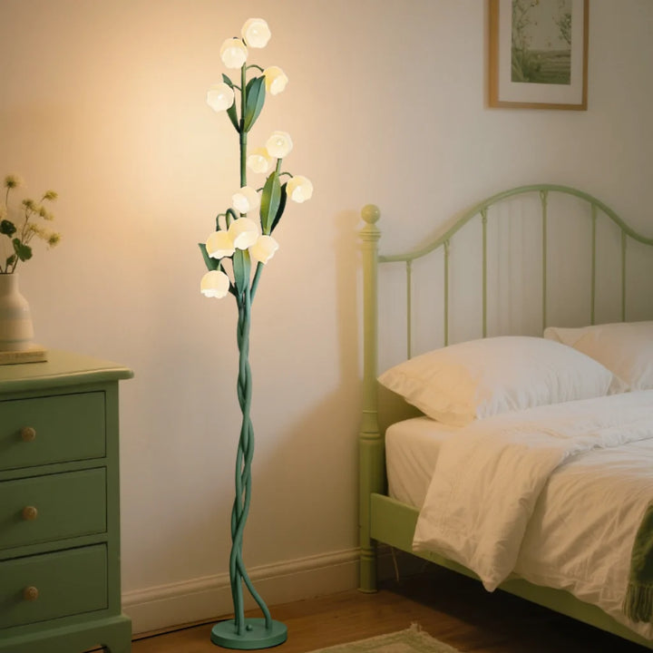Lily Bloom Acrylic Floor Lamp glowing warm white light in a bedroom setting