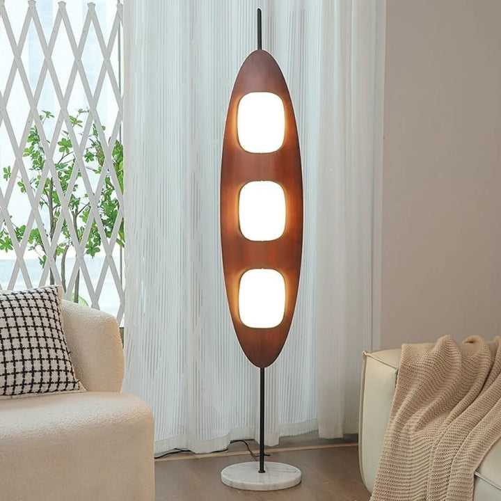 Walnut Yacht Silhouette Floor Lamp - lit ambient glow in living room