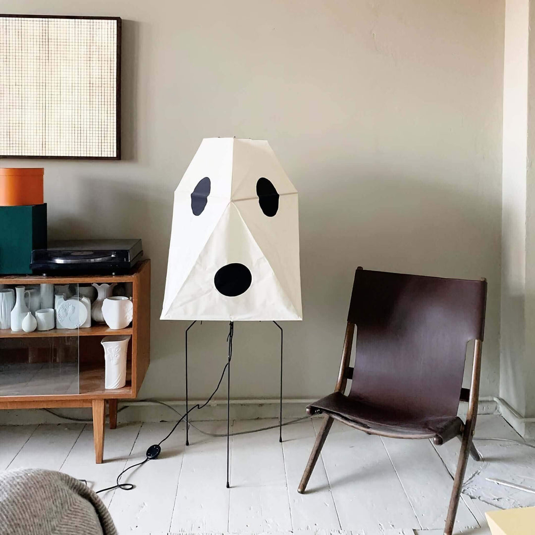 Modern minimalist rice paper floor lamp with playful design in a stylish living room setting.