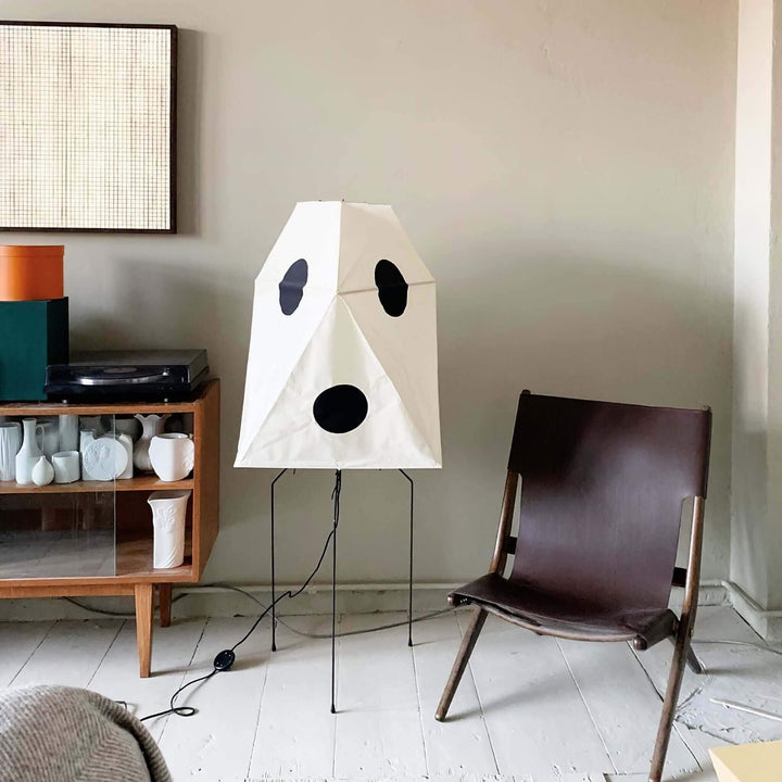 Modern minimalist rice paper floor lamp with playful design in a stylish living room setting.