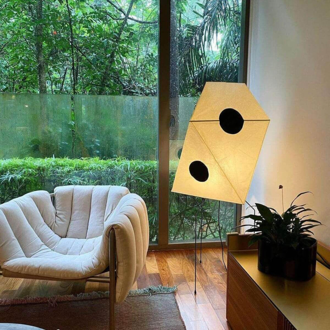 Akari UF3-Q white rice paper floor lamp with tripod base in a minimalist living room setting.