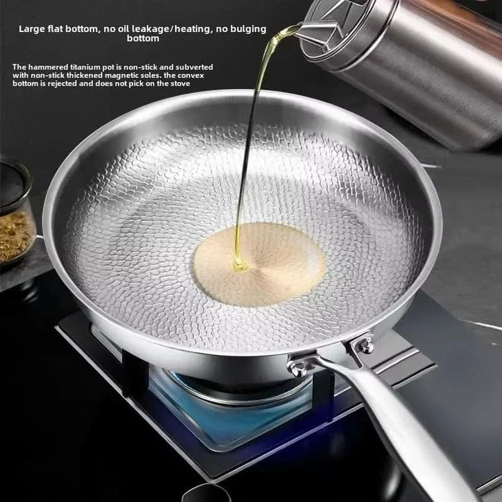 Stainless Steel Hammered Skillet on stovetop pouring oil
