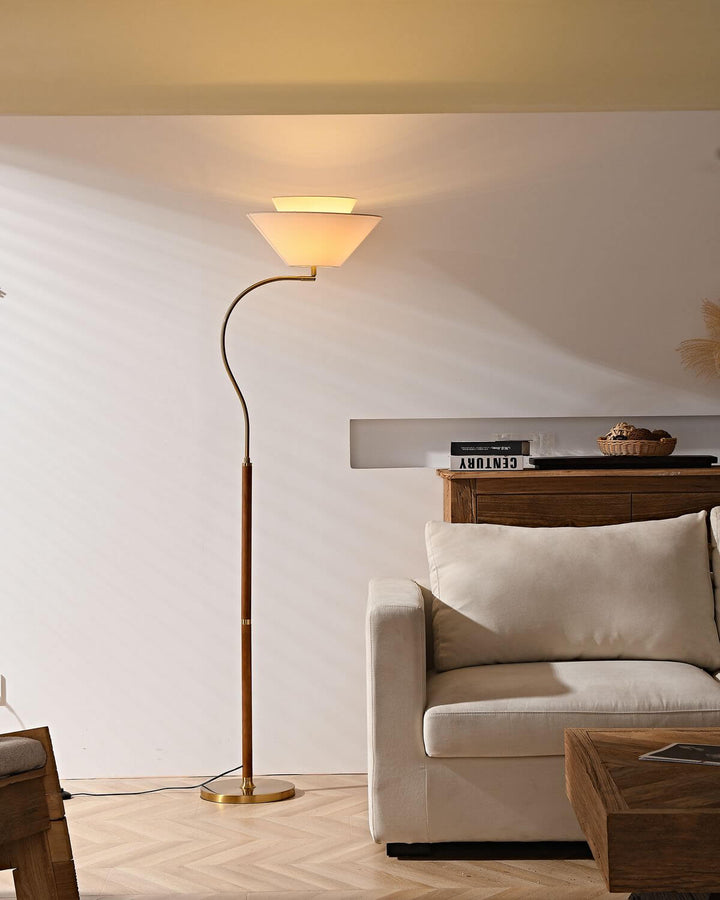 Stylish Nelke floor light, a curved wooden lamp, perfect for minimalist decor over a sofa, adding elegant illumination.