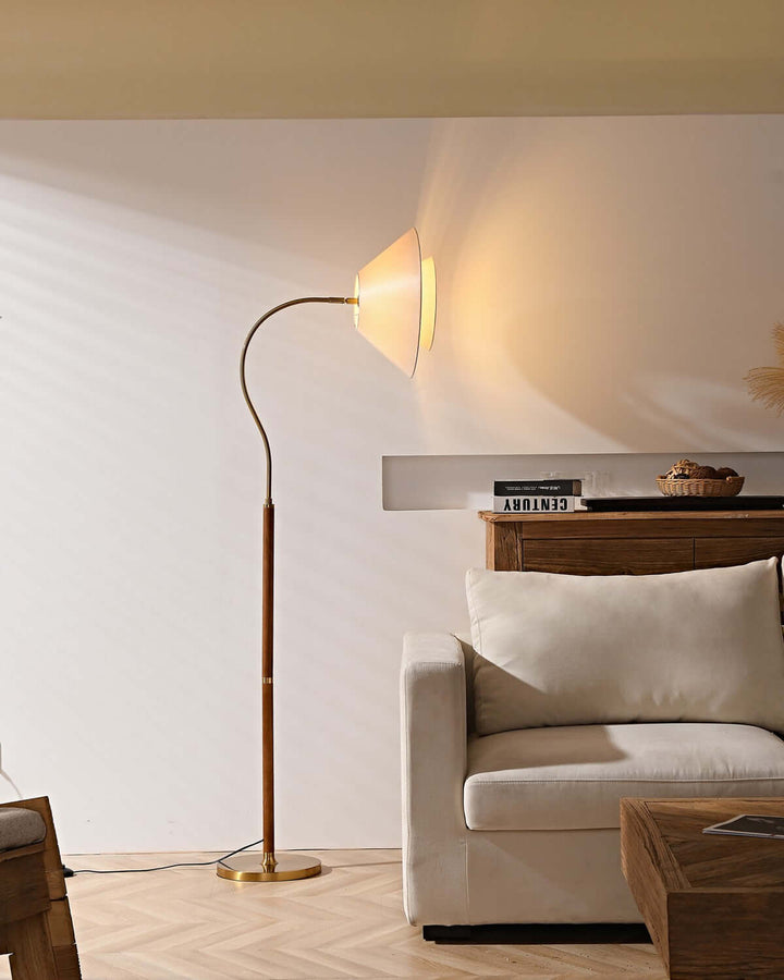 Nelke Floor Light featuring a curved design, wooden lamp base, perfect for minimalist decor over a sofa.
