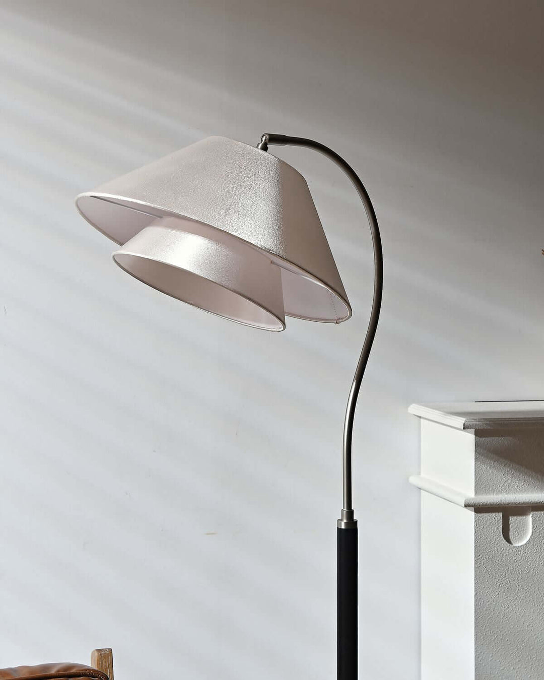 Nelke Floor Light, a minimalist curved wooden lamp with elegant dual shades, perfect for over sofa lighting.