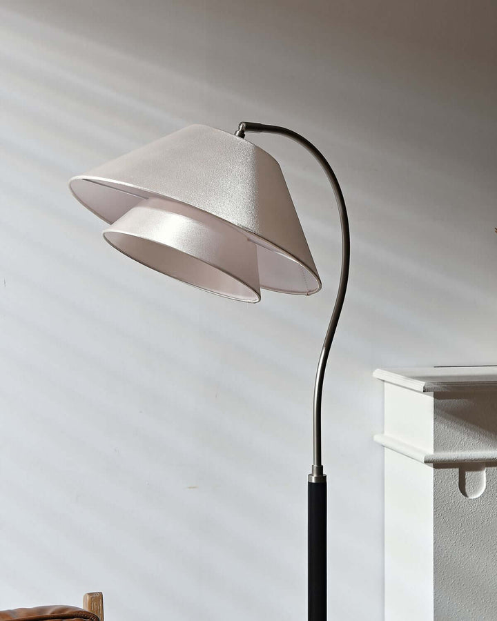 Nelke Floor Light, a minimalist curved wooden lamp with elegant dual shades, perfect for over sofa lighting.