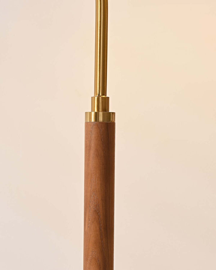 Close-up of a wooden lamp floor with a brass finish, showcasing minimalist design and elegant craftsmanship.