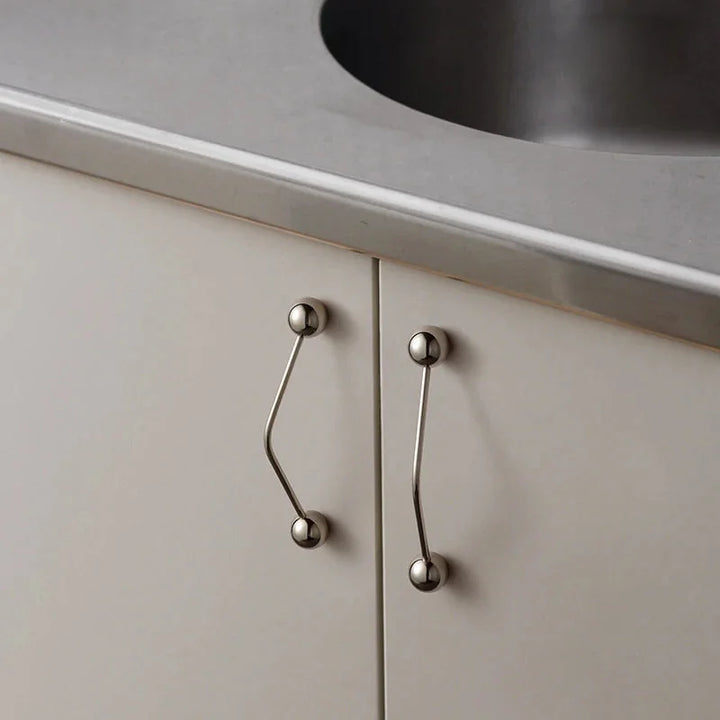 Kinetic Line Brass Knob and Pull installed on kitchen cabinets lifestyle