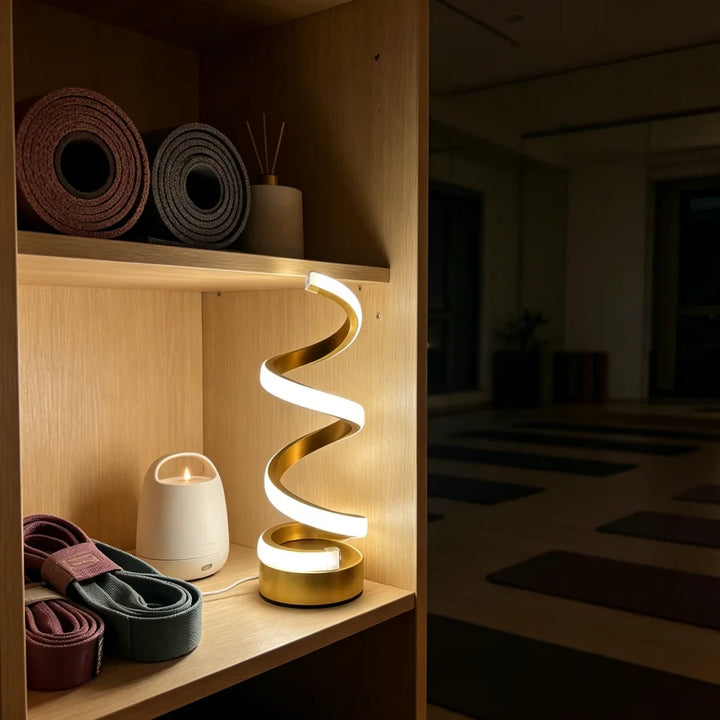 Gold Spiral Desk Lamp lit warm white glow