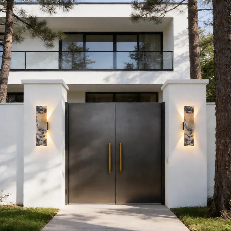 Marble Wall Sconce flanking modern entrance gate