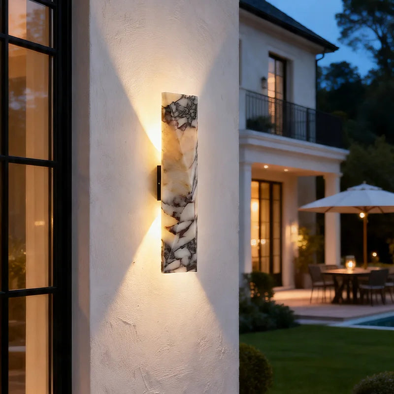 Marble Wall Sconce illuminated on exterior wall at night