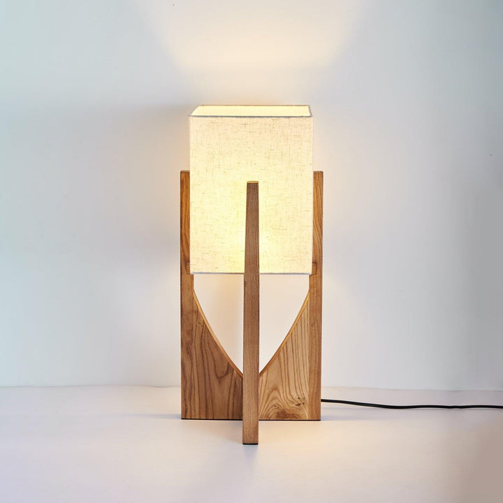Wooden mid century floor lamp with soft light, perfect for bedrooms or modern decor.