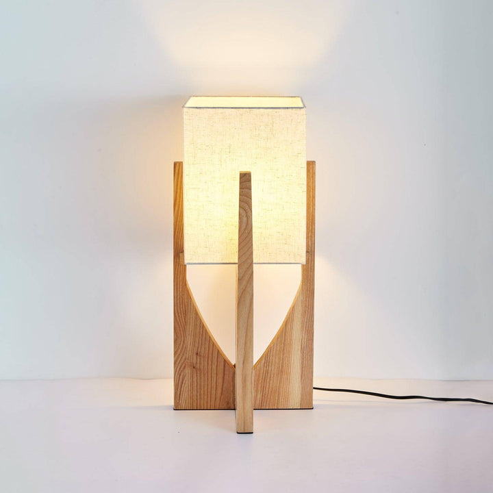 Fairbanks Floor Lamp with wooden base and square fabric lampshade, perfect mid-century style for bedroom decor.