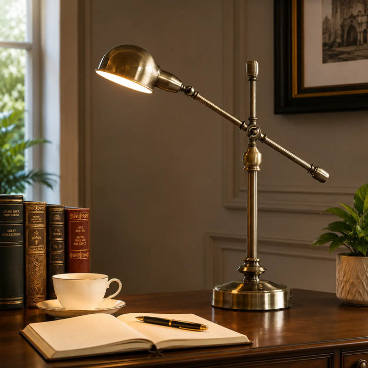 Antique brass adjustable desk lamp on tabletop