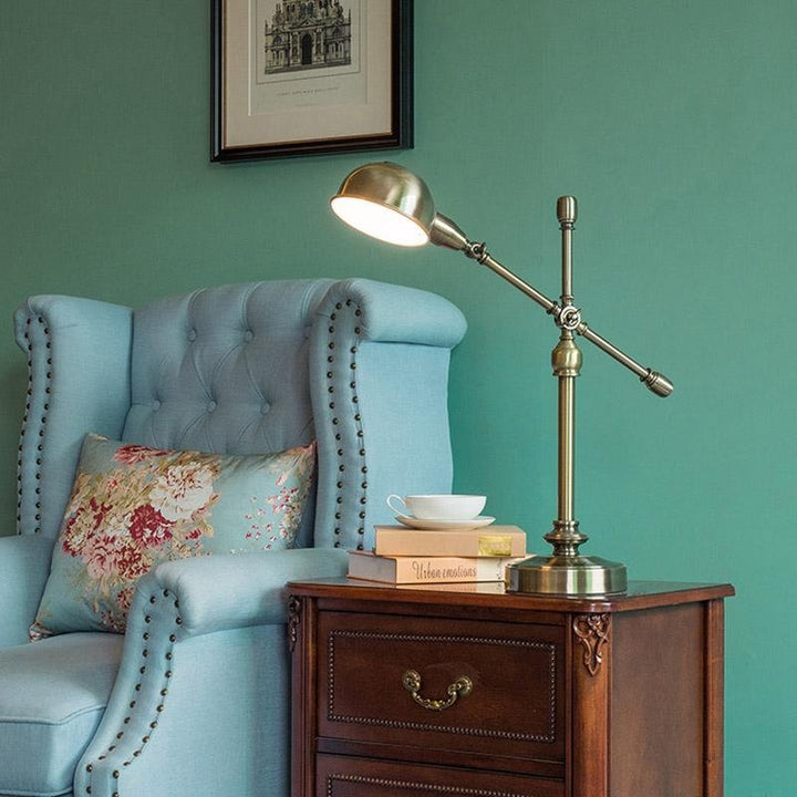 Antique brass desk lamp arm extended for task lighting