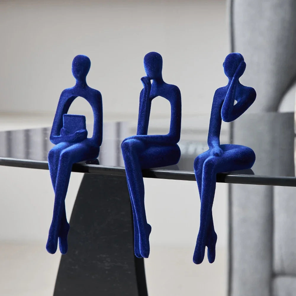 Blue Abstract Thinker Shelf Sitter Figurines on table edge