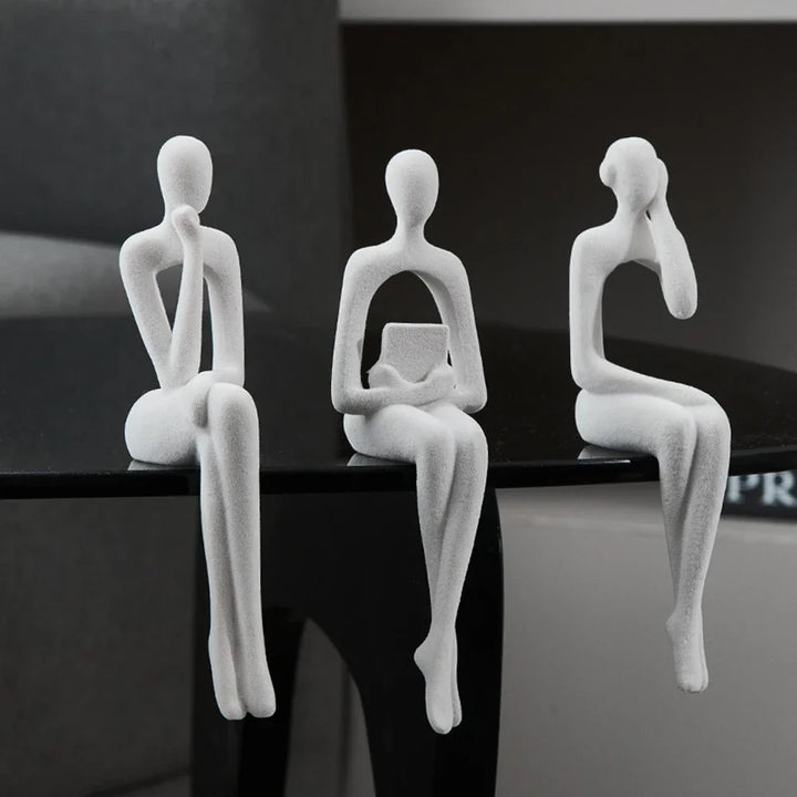 Off-White Abstract Thinker Shelf Sitter Figurines on table edge