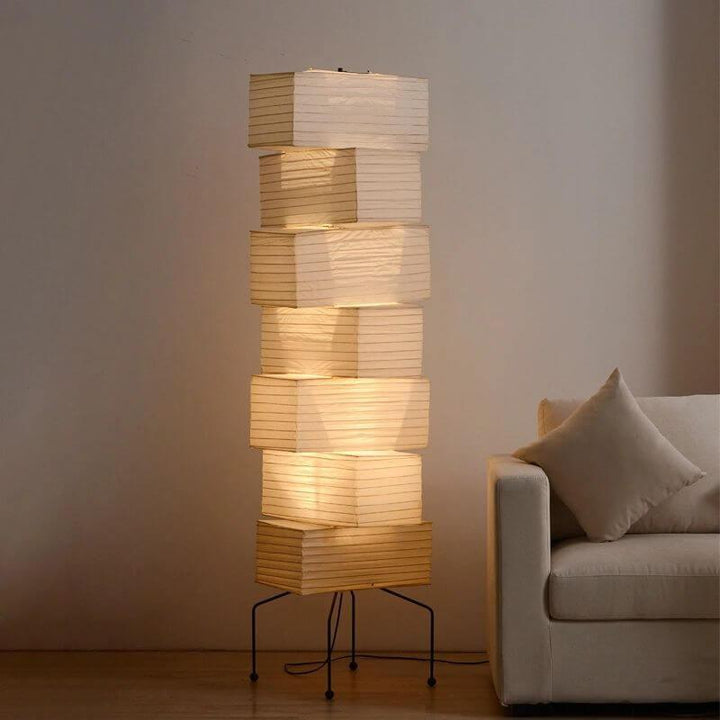 White Akari Paper Floor Lamp beside a white sofa