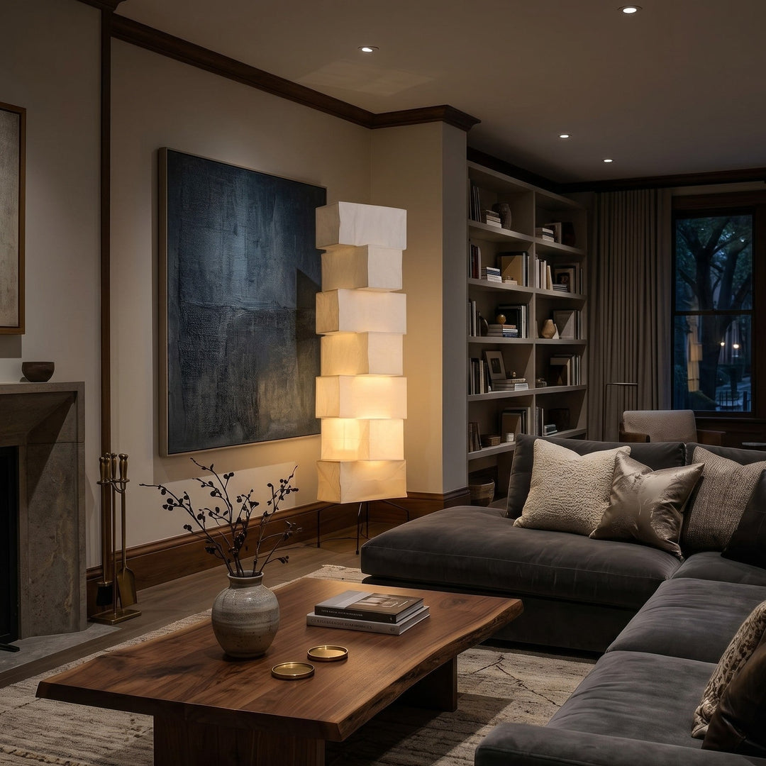 White Akari Paper Floor Lamp between a fireplace and bookshelf
