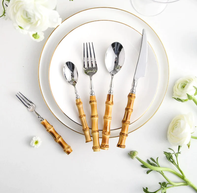 Bamboo Handle Stainless Steel Flatware Set beside plate