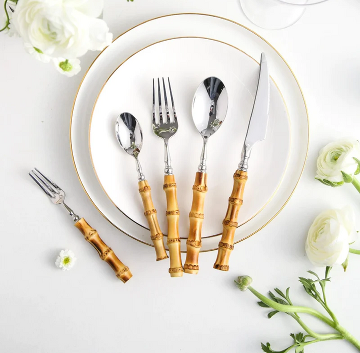 Bamboo Handle Stainless Steel Flatware Set beside plate