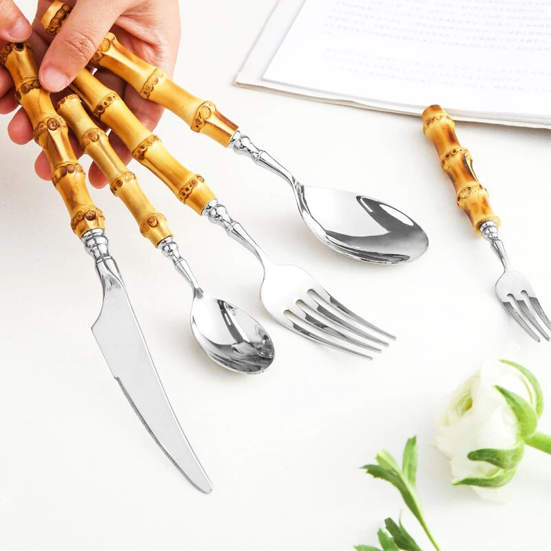 Bamboo Handle Stainless Steel Flatware Set in hand