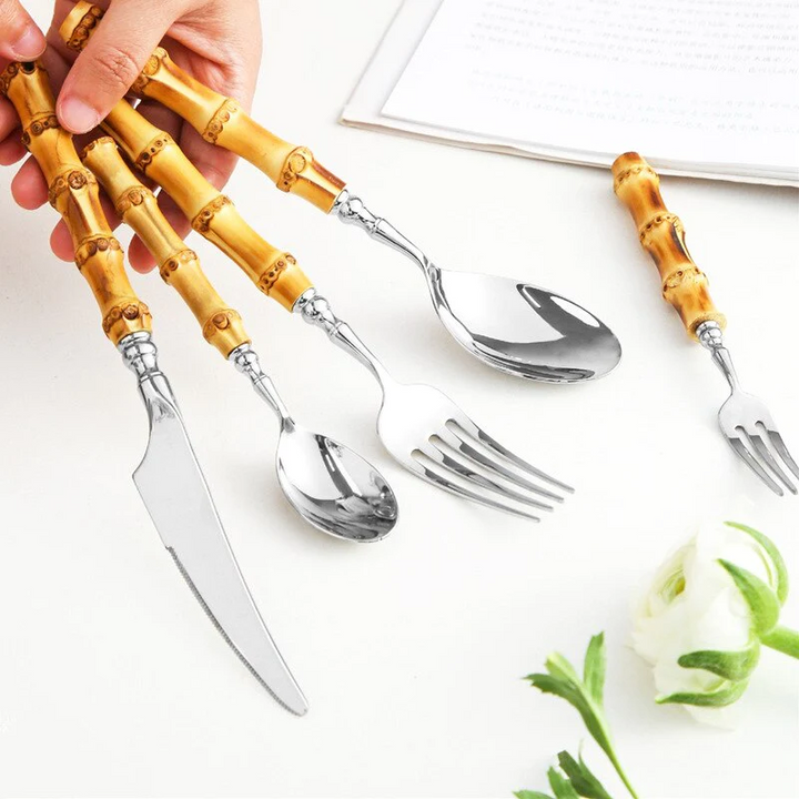 Bamboo Handle Stainless Steel Flatware Set in hand