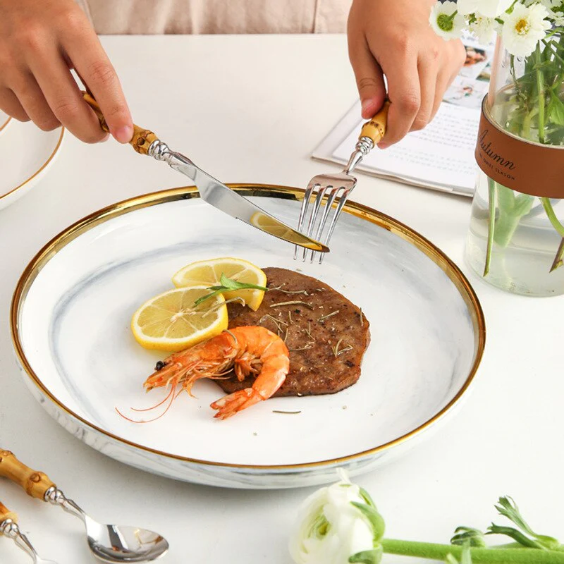 Bamboo Handle Stainless Steel Flatware Set in use at dinner