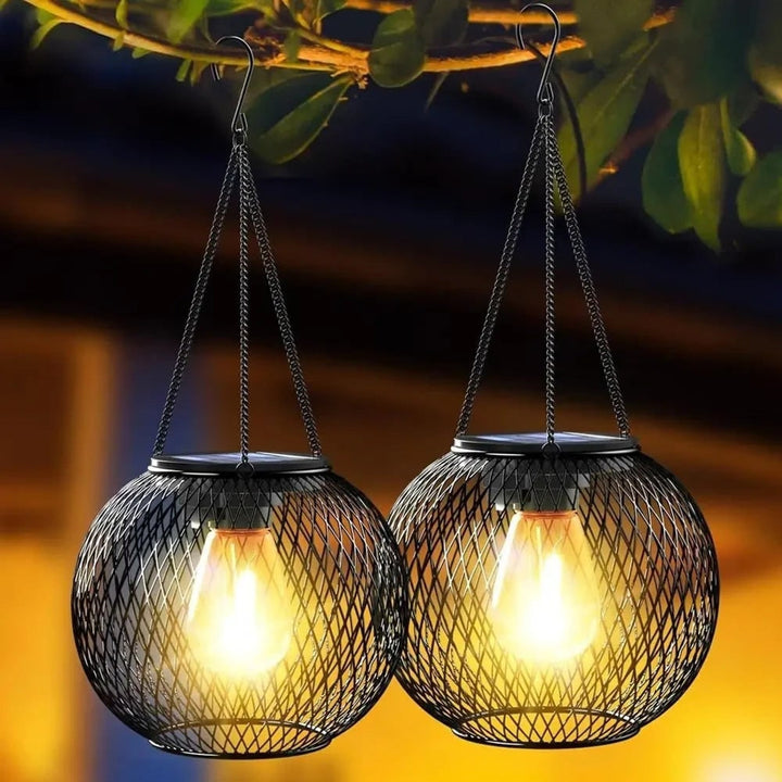 Black metal solar lantern hanging with warm white LED glow at dusk
