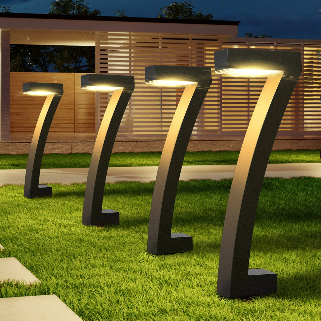 Black Solar Pathway Lights in a row on lawn at dusk