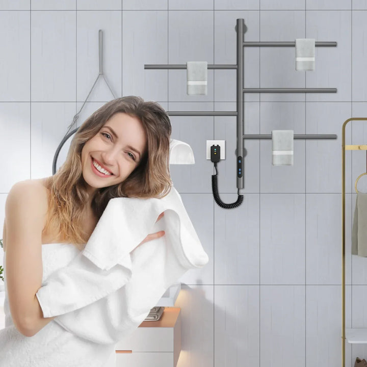 Black heated towel rack mounted in a bathroom