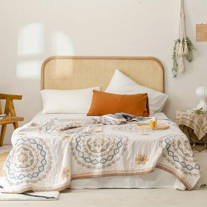 Bohemian Mandala Cotton Throw covering a bed