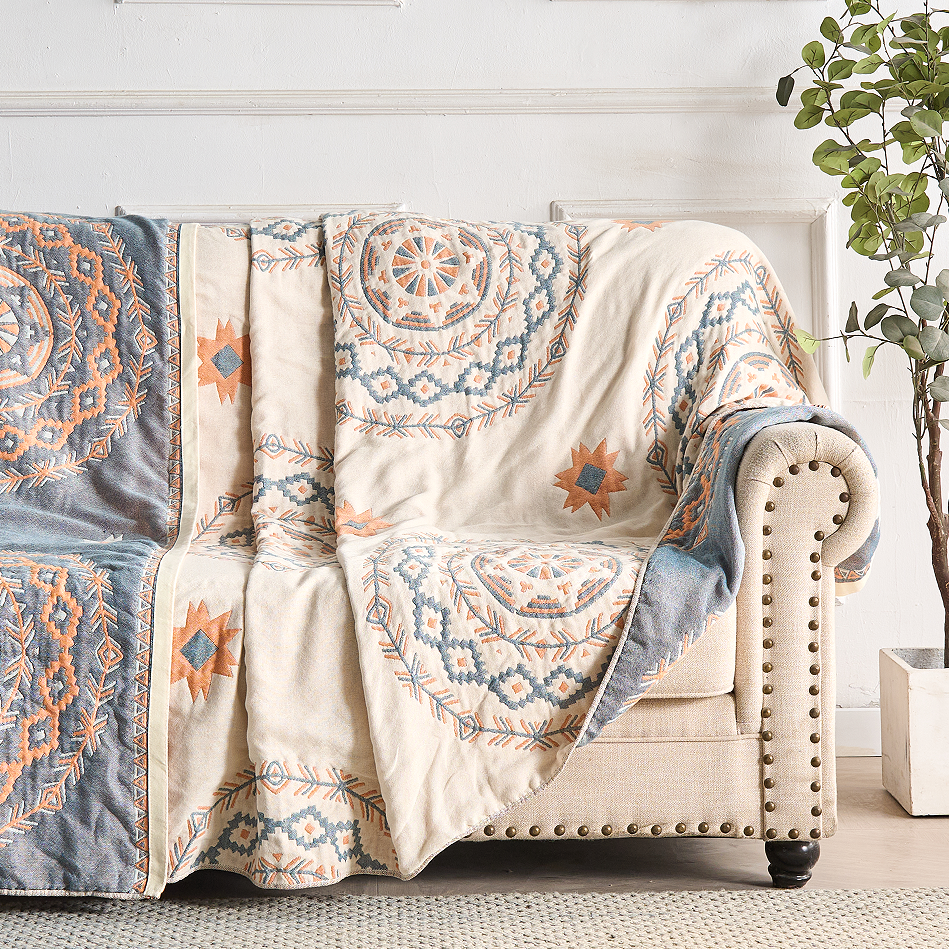 Bohemian Mandala Cotton Throw draped over a sofa