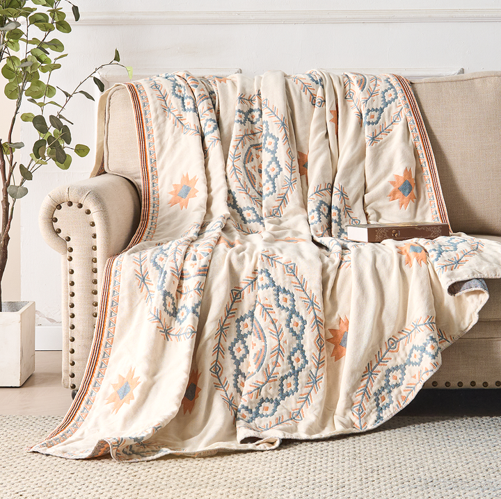 Bohemian Mandala Cotton Throw fringed edge over a sofa arm