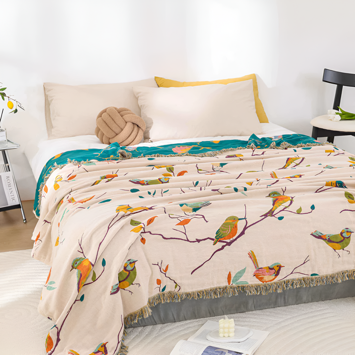 Boho Bird Print Cotton Throw covering a bed