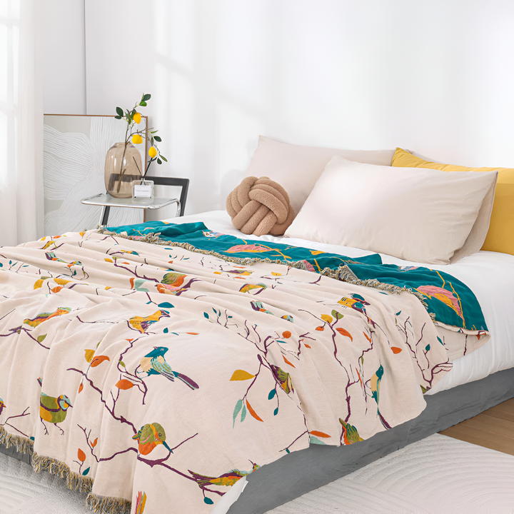 Boho Bird Print Cotton Throw bird and branch motif on a bed