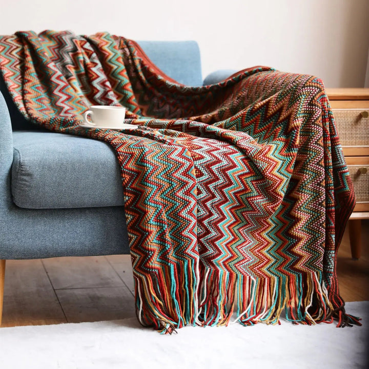 Red Boho Chevron Knit Throw Blanket draped on sofa
