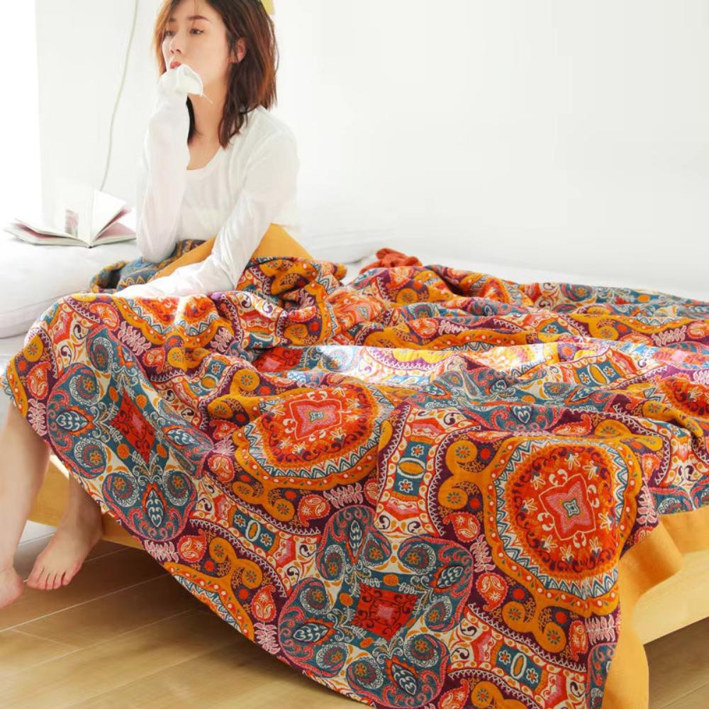 Boho Medallion Cooling Cotton Throw draped over a bed
