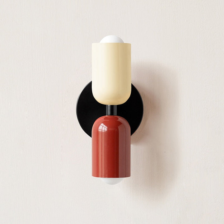 Pink Bold Matte Twin-Bulb Sconce lit on wall