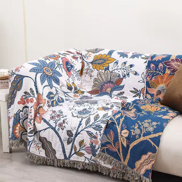 Blue botanical print cotton throw blanket on sofa