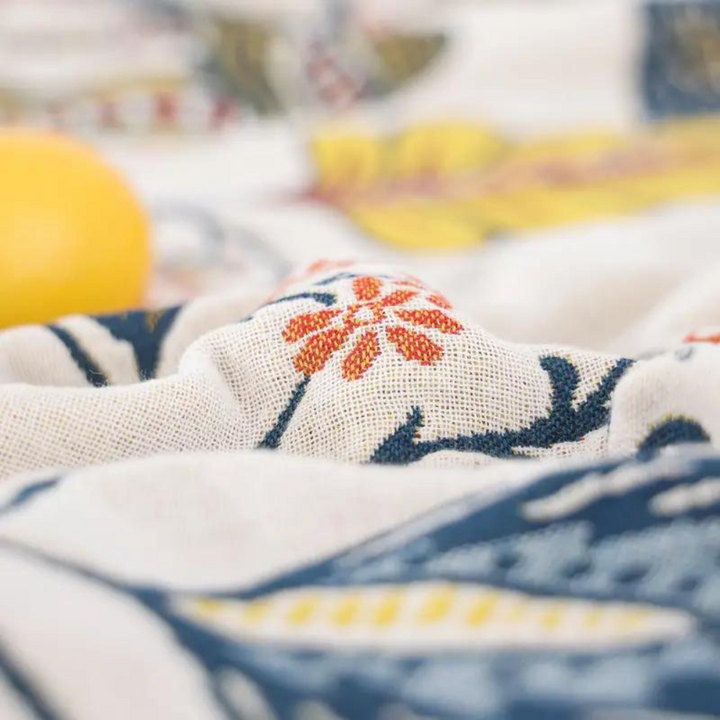Blue botanical print cotton throw blanket on bed