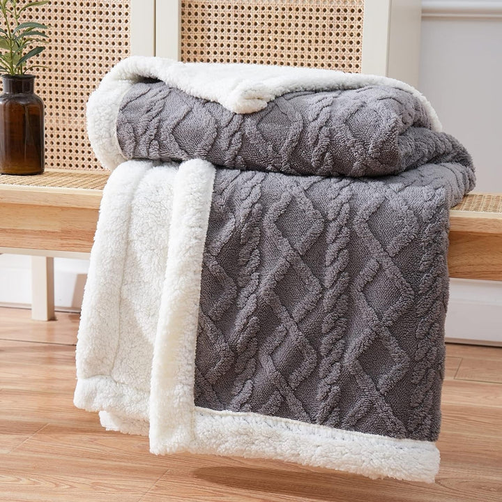 Charcoal Brushed Sherpa Fleece Throw folded on a sofa
