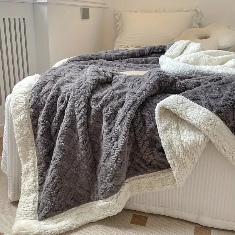 Charcoal Brushed Sherpa Fleece Throw open on a sofa