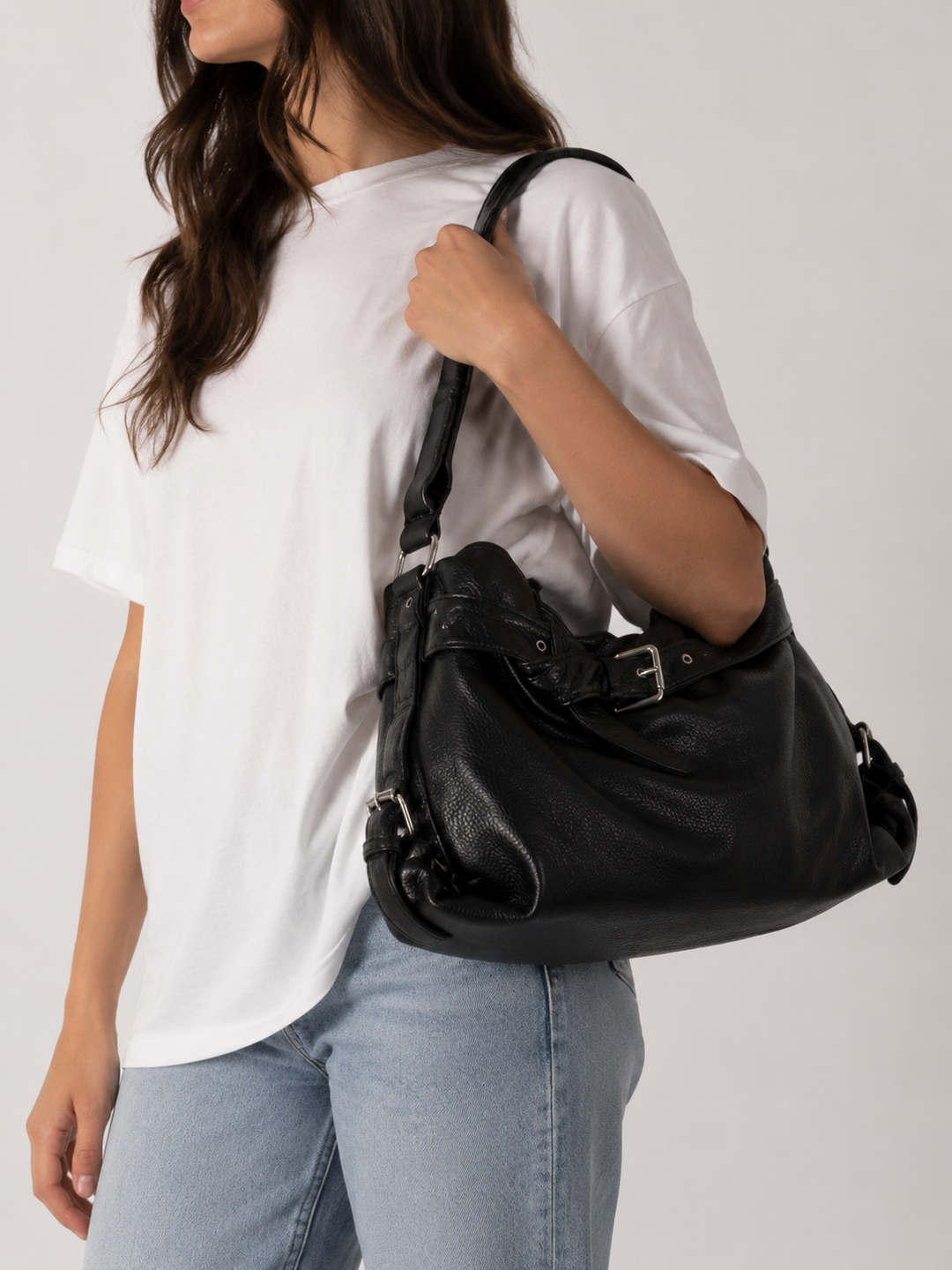 Black Buckle-Strap Vegan Leather Hobo Bag worn on shoulder