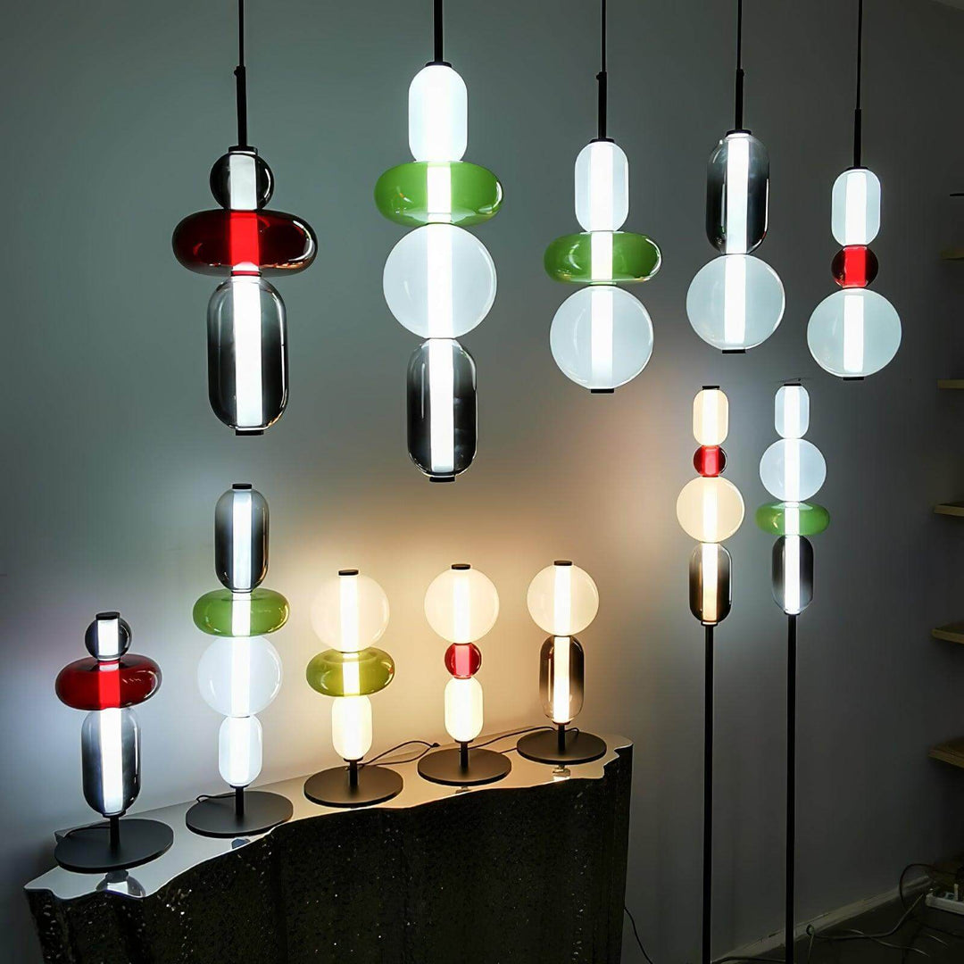 Collection of colorful Candied glass pendant, table, and floor lamps displayed in multiple stacked designs.