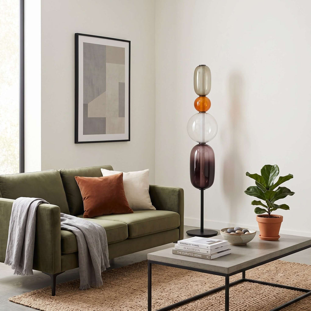 Orange Candied Glass Floor Lamp Model B, unlit, beside a green sofa