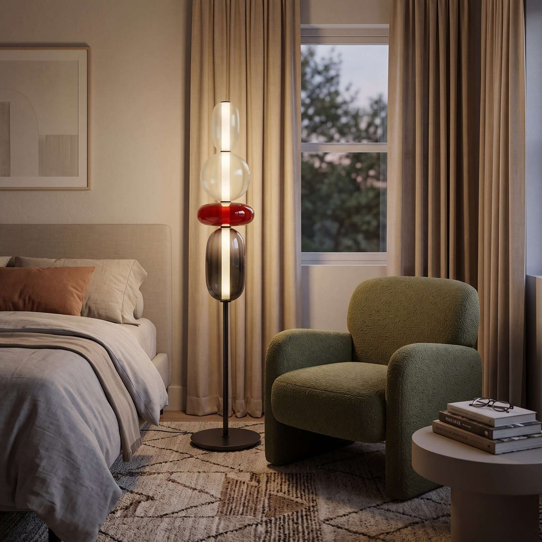 Red Candied Glass Floor Lamp beside a green armchair in a cozy bedroom
