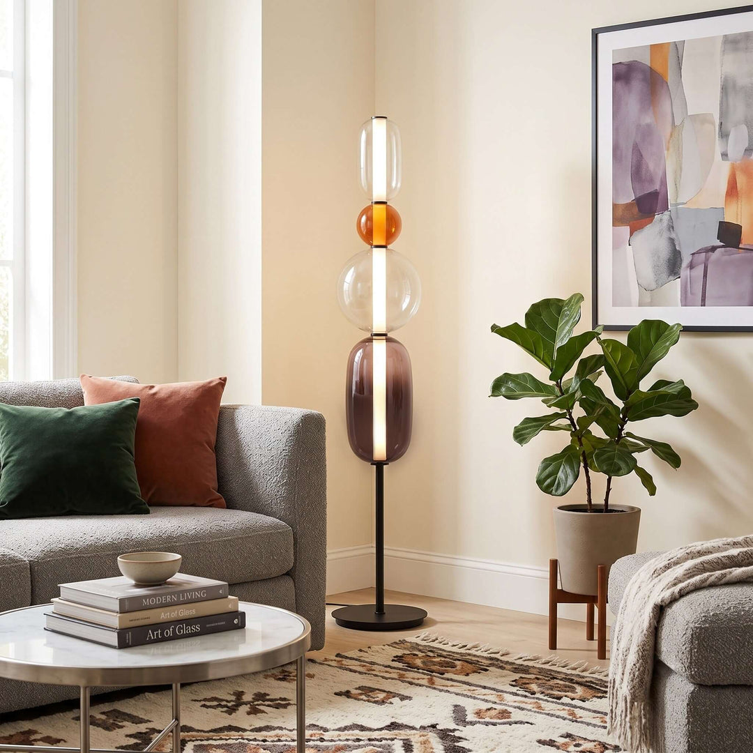 Orange Candied Glass Floor Lamp Model B beside a gray sofa and potted plant